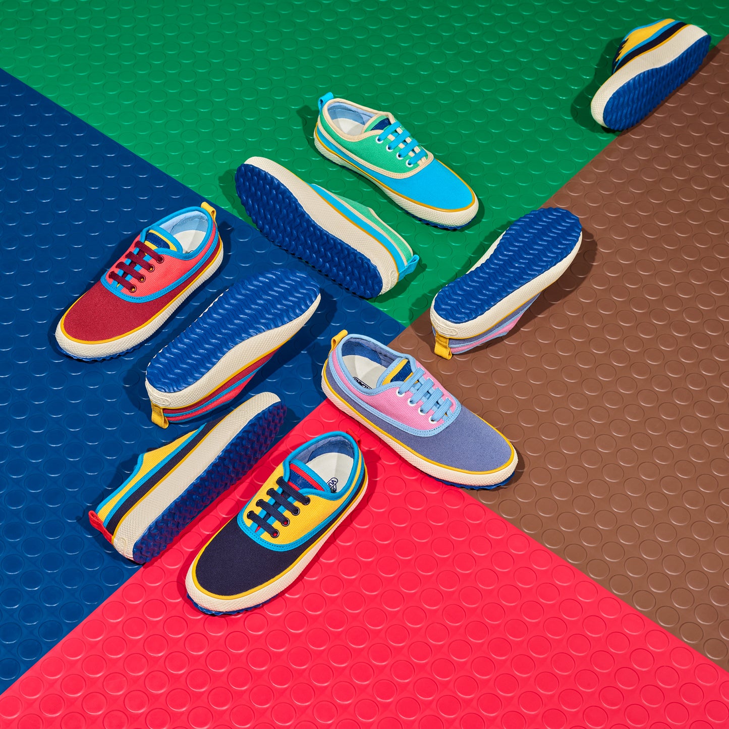 Colorful sneakers on a multicolored geometric patterned surface. 